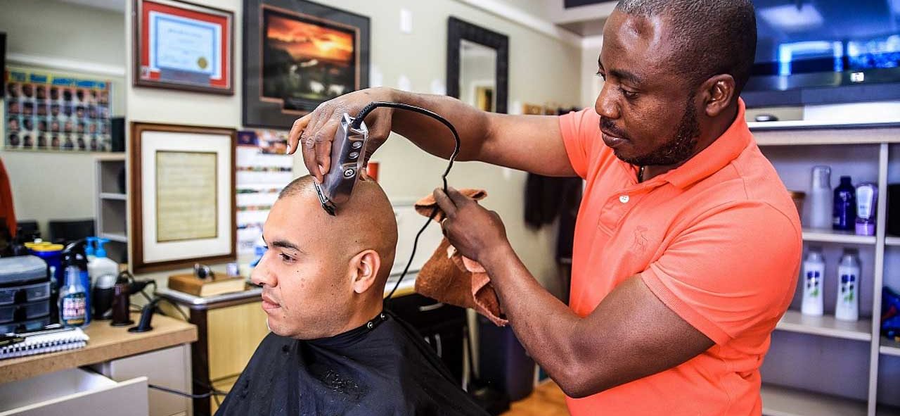 man getting haircut from barber